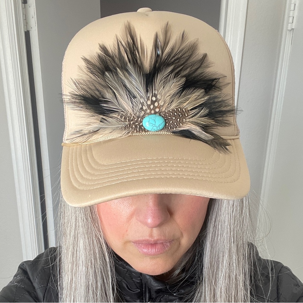Tan trucker hat with feathers